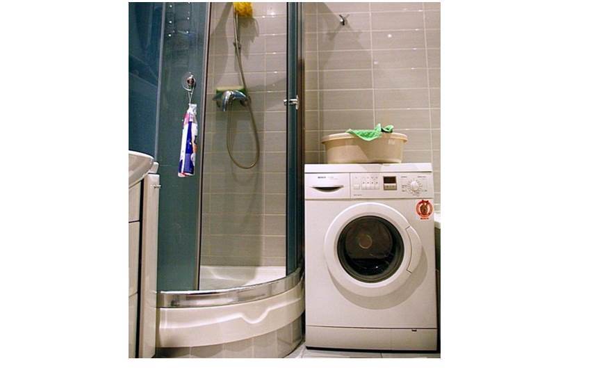 shower and washing machine in the bathroom