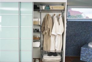 terry robes in a drying closet