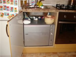 a compact dishwasher in a small kitchen