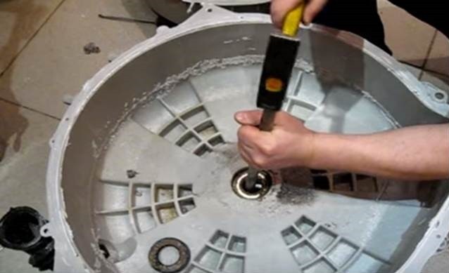 We remove the old bearings and seal using a drift