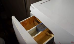 There is water left in the conditioner compartment of the washing machine.