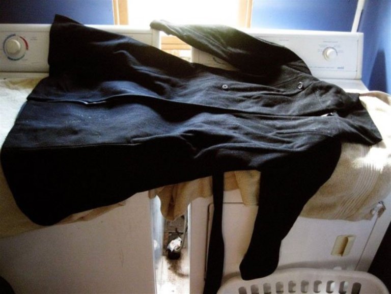 Lay the coat on a horizontal surface away from heating devices.