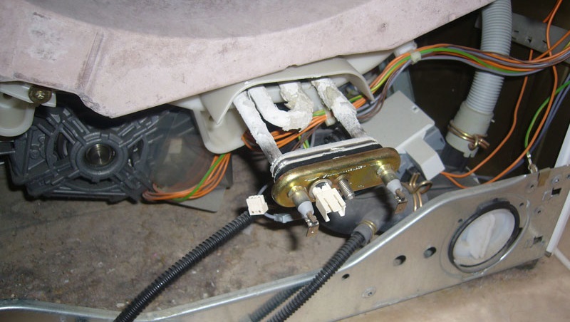 We remove the heating element and pull the sock out of the tank through its hole