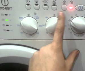 How to stop an Indesit washing machine during a wash cycle?