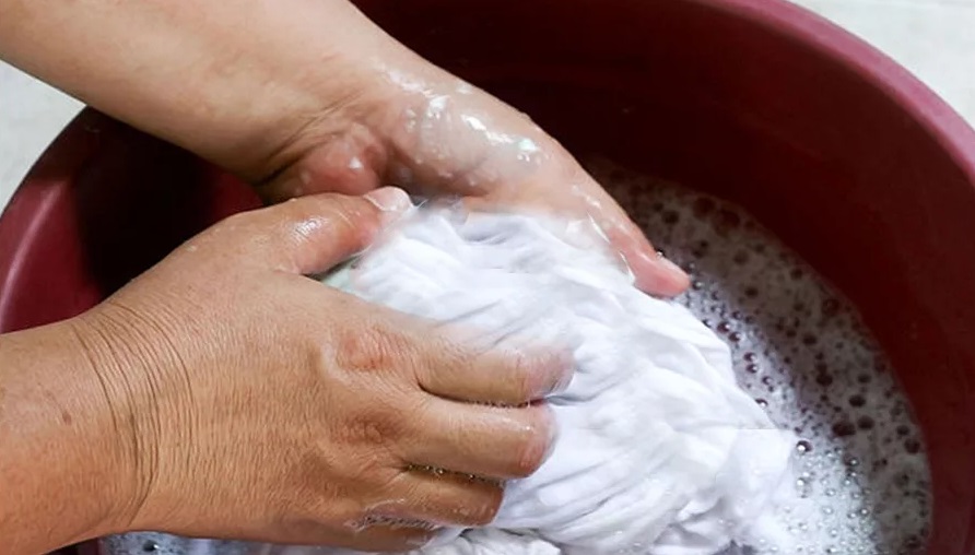hand washing a white shirt