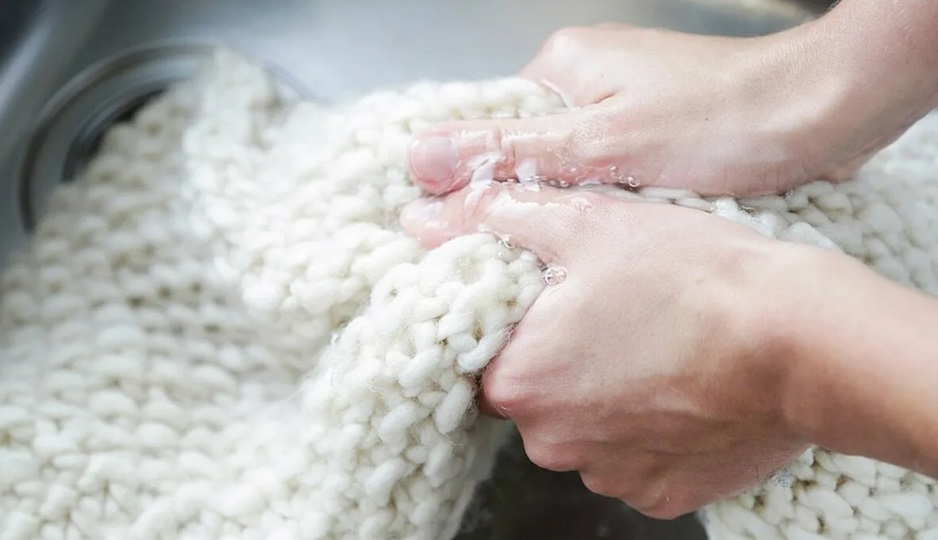 hand washing a knitted cardigan