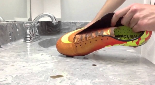 cleaning the boots with a toothbrush