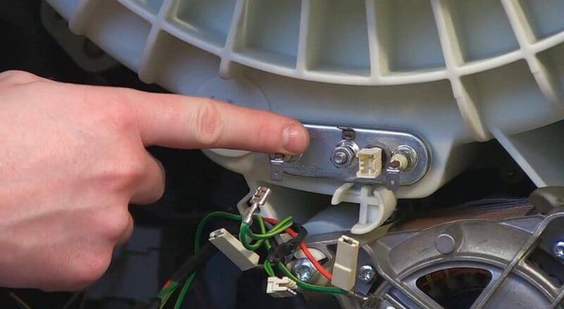 The heating element is located at the back of the tank.