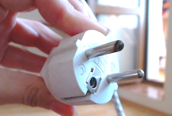 Why does the electrical outlet get hot when the washing machine is running?