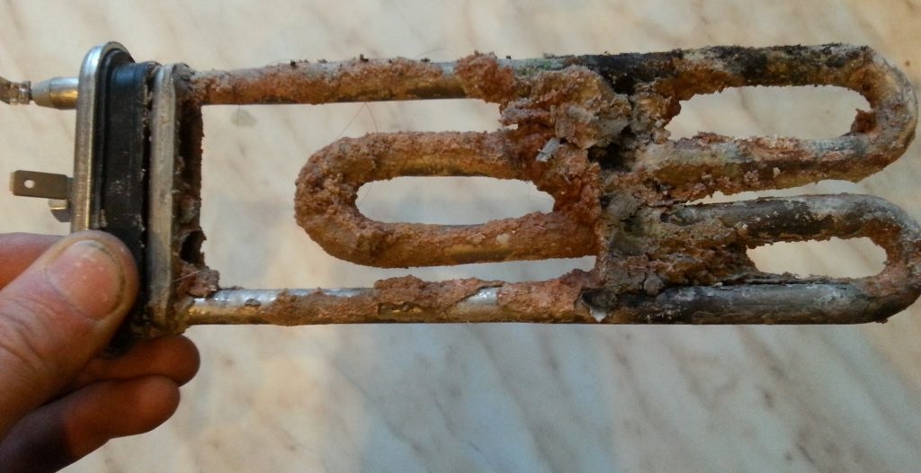 powder particles and scale on the heating element