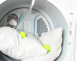 Can you dry a feather pillow in the dryer?