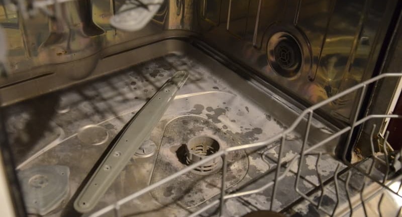 We clean the dishwasher's washing chamber.