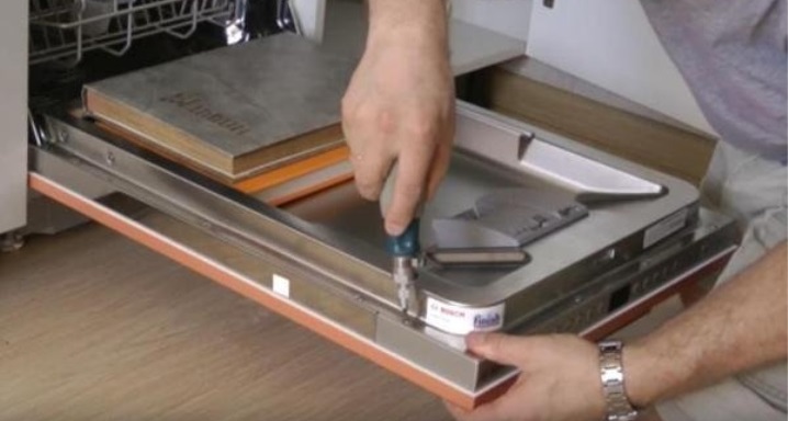 Removing the decorative panel from the dishwasher door