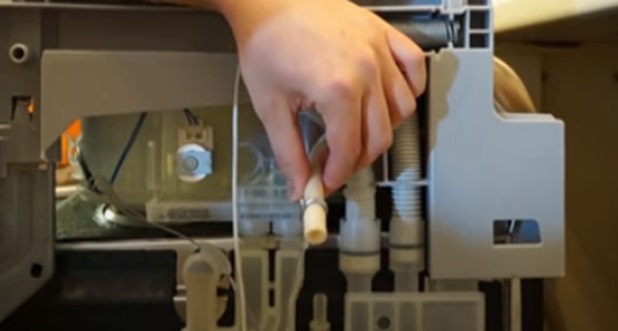 loosen the clamp and disconnect the dishwasher hose