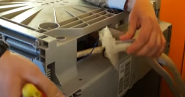 remove the panel that mounts the drain and inlet hoses of the dishwasher