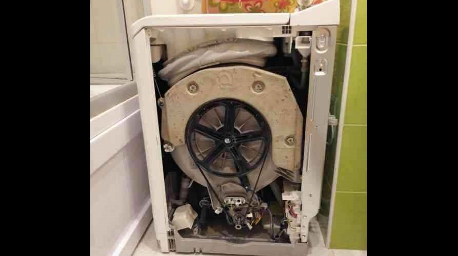 Removing the side panel of a top-loading washing machine