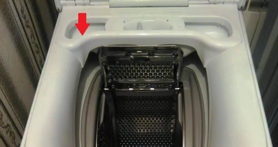 There is powder left in the top-loading washing machine tray.